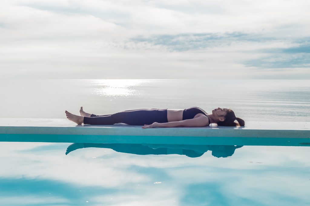 Young Asian woman laying down meditating